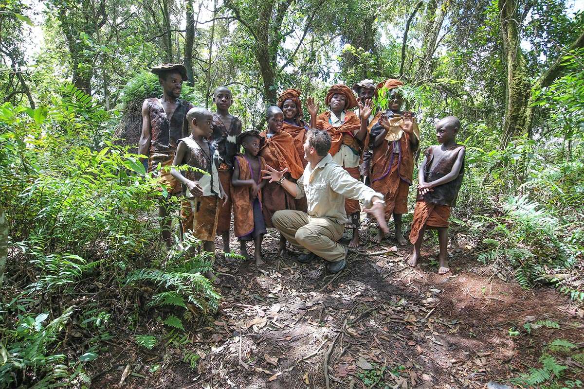 Community Impact - a tourist engaging with the Batwa communities living outside the gorilla forest in Bwindi