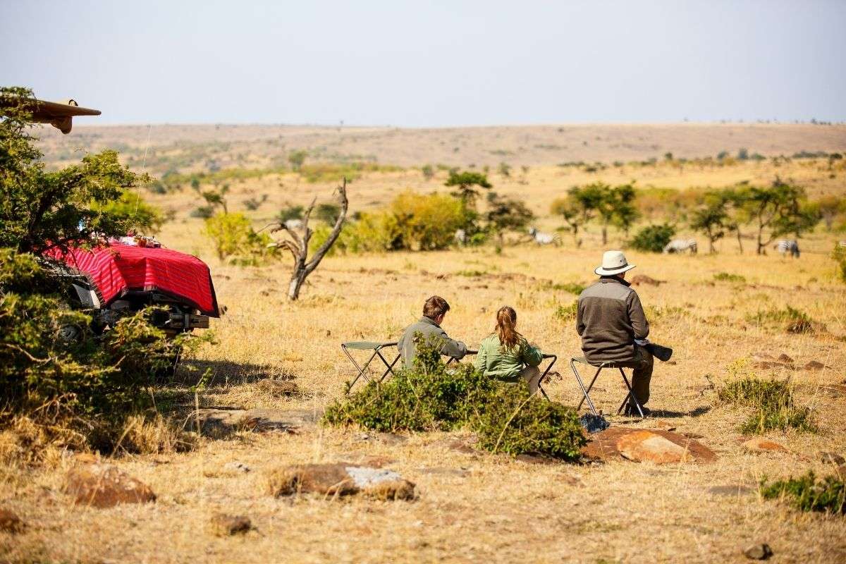 Family relaxes on the svannah plains of the Serengeti. Gorilla Encounter, Serengeti Big Game and Zanzibar's Tucked Away Beaches | 16 Days, 4 Destinations