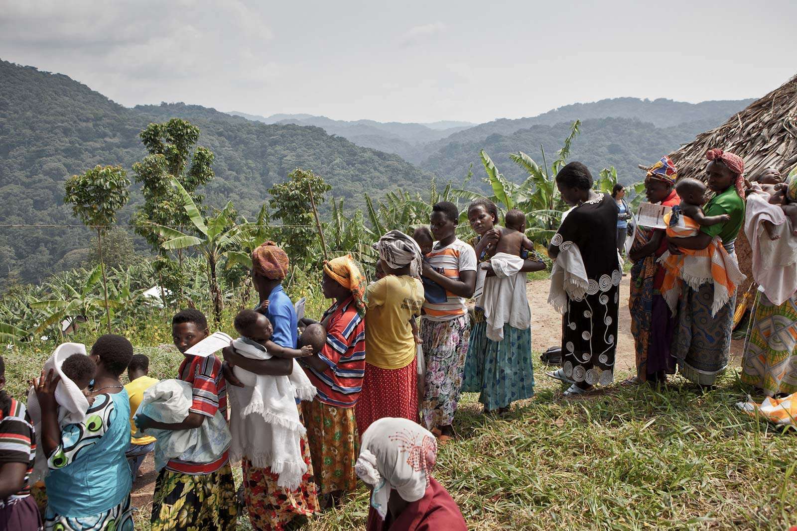 Women line up at a gathering outside the gorilla forest